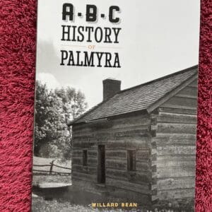 A book cover with an old log cabin.