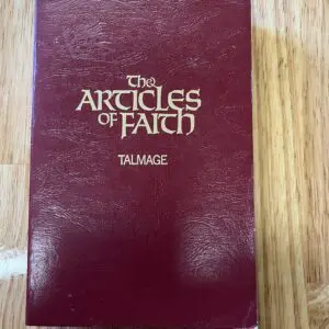 A red book sitting on top of a wooden table.