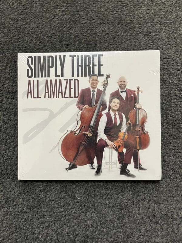 A cd cover with three men playing musical instruments.