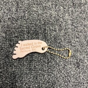A wooden key chain with the words " father to be " engraved on it.