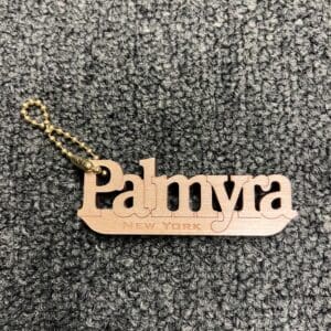 A wooden keychain with the name palmyra written on it.