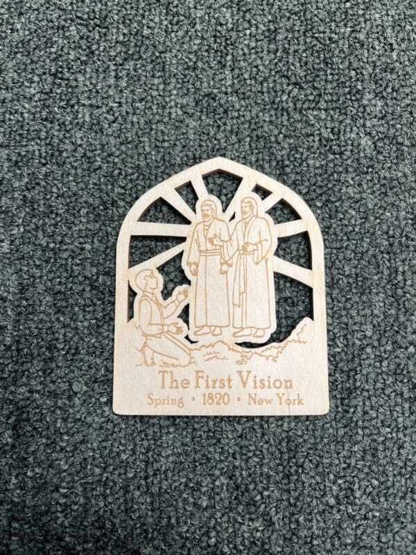 A wooden plaque with the words " the first vision."