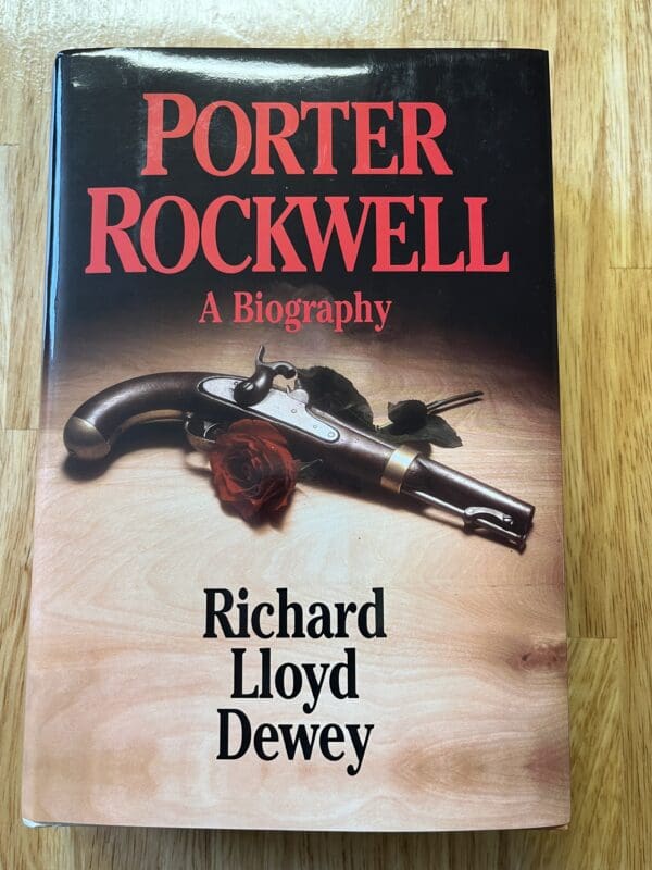 A book cover with a gun and roses on the front.