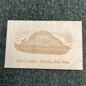 A wooden plaque with an image of a mountain.