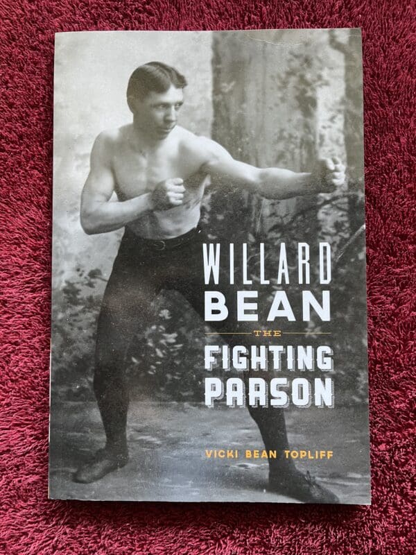 A book cover with an old photo of a man in boxing gear.