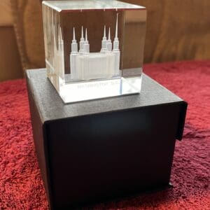 A small glass cube with a castle on it