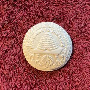 A white object sitting on top of a red carpet.