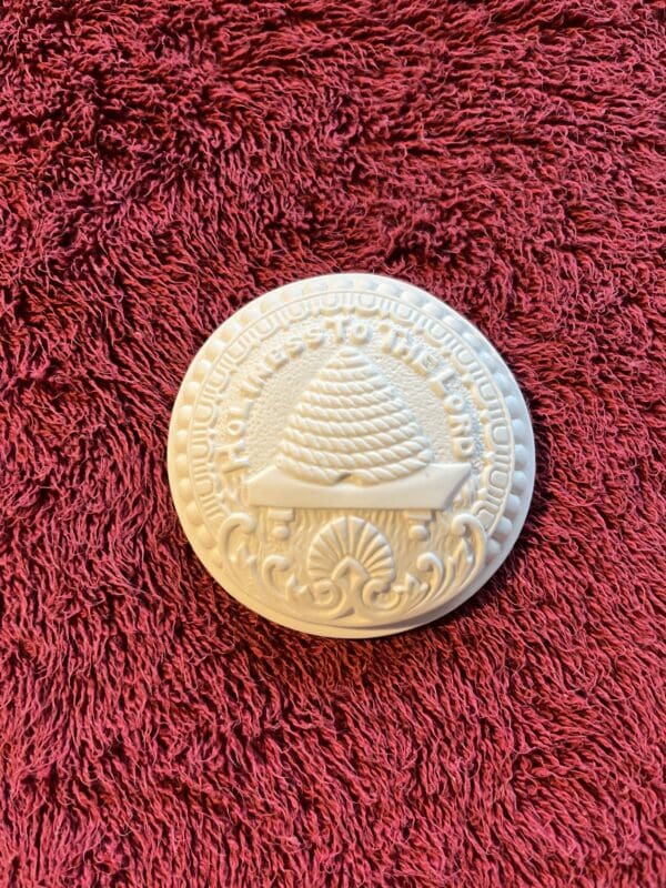 A white object sitting on top of a red carpet.