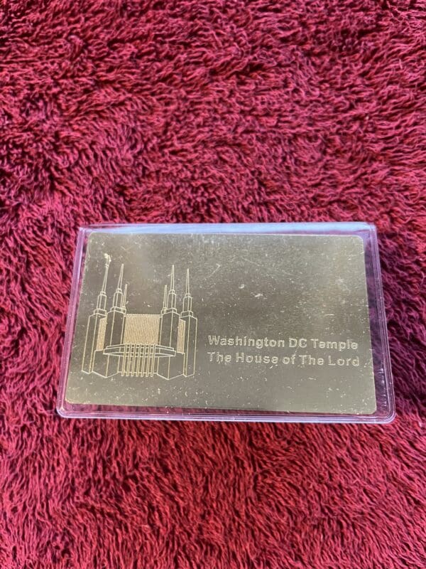 A metal card with the words " there is no temple ".