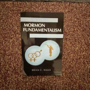 A book on mormon fundamentalism is laying on the floor.