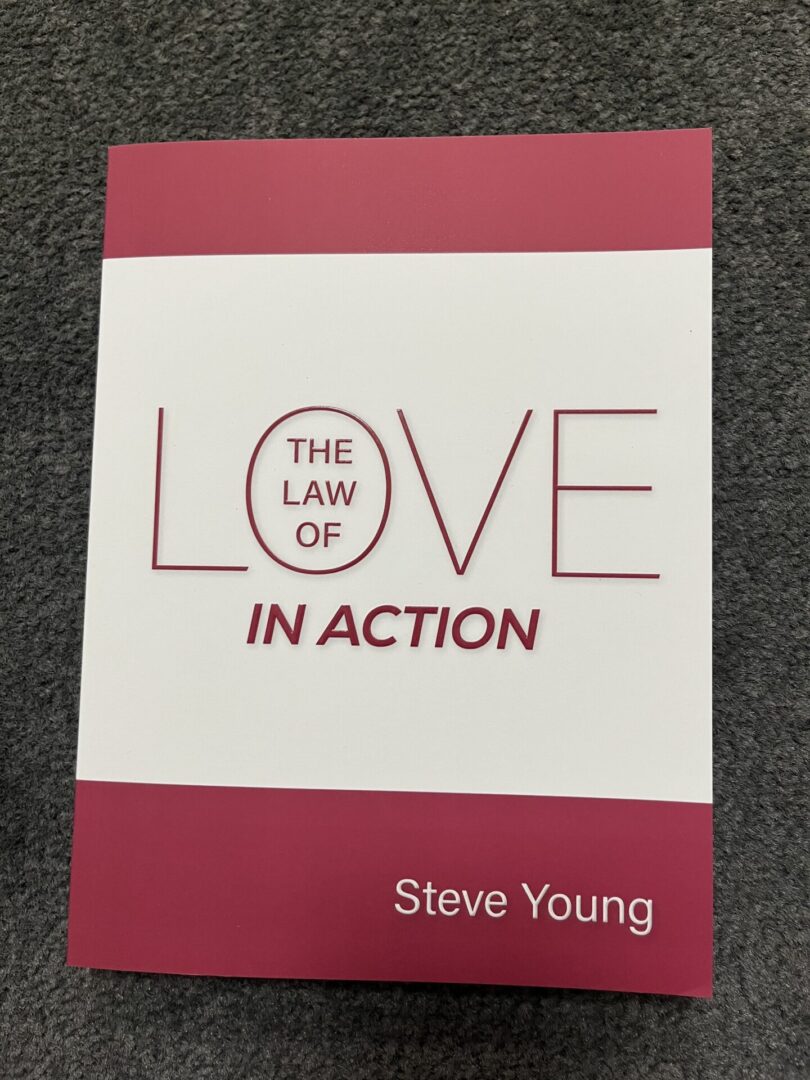 A book cover with the title of " the law of love in action ".