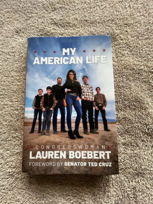 A book cover with a group of people standing on top of it.