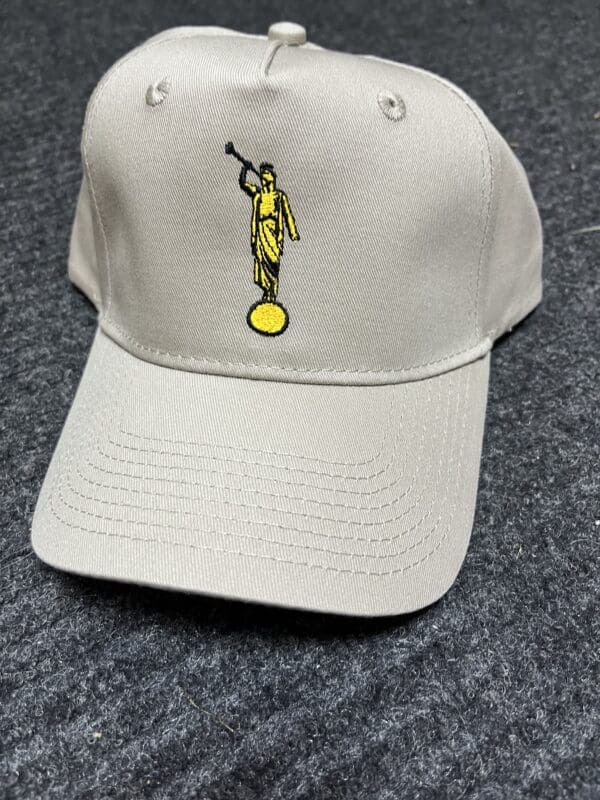 Beige baseball cap with angel design.